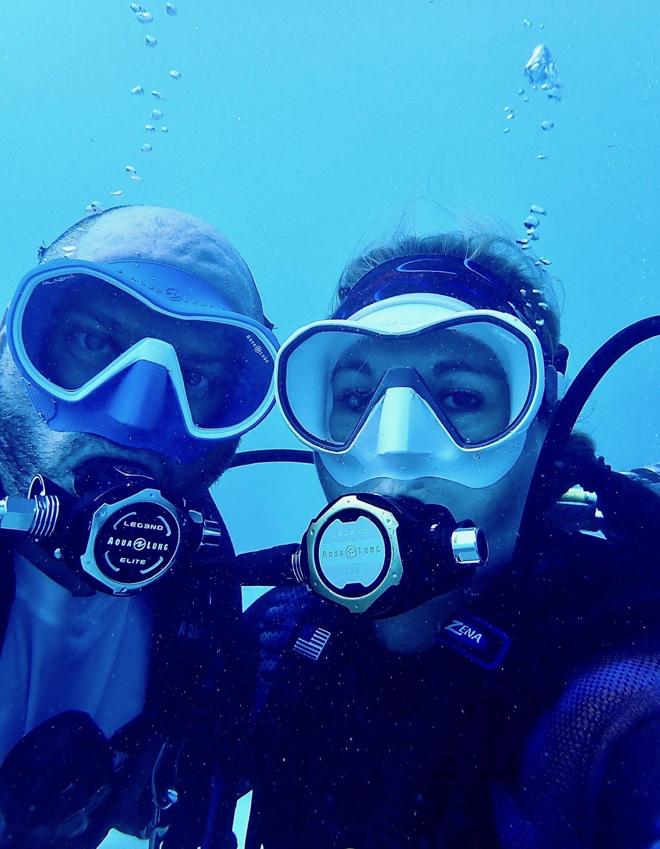 Chad and Jessica diving together underwater